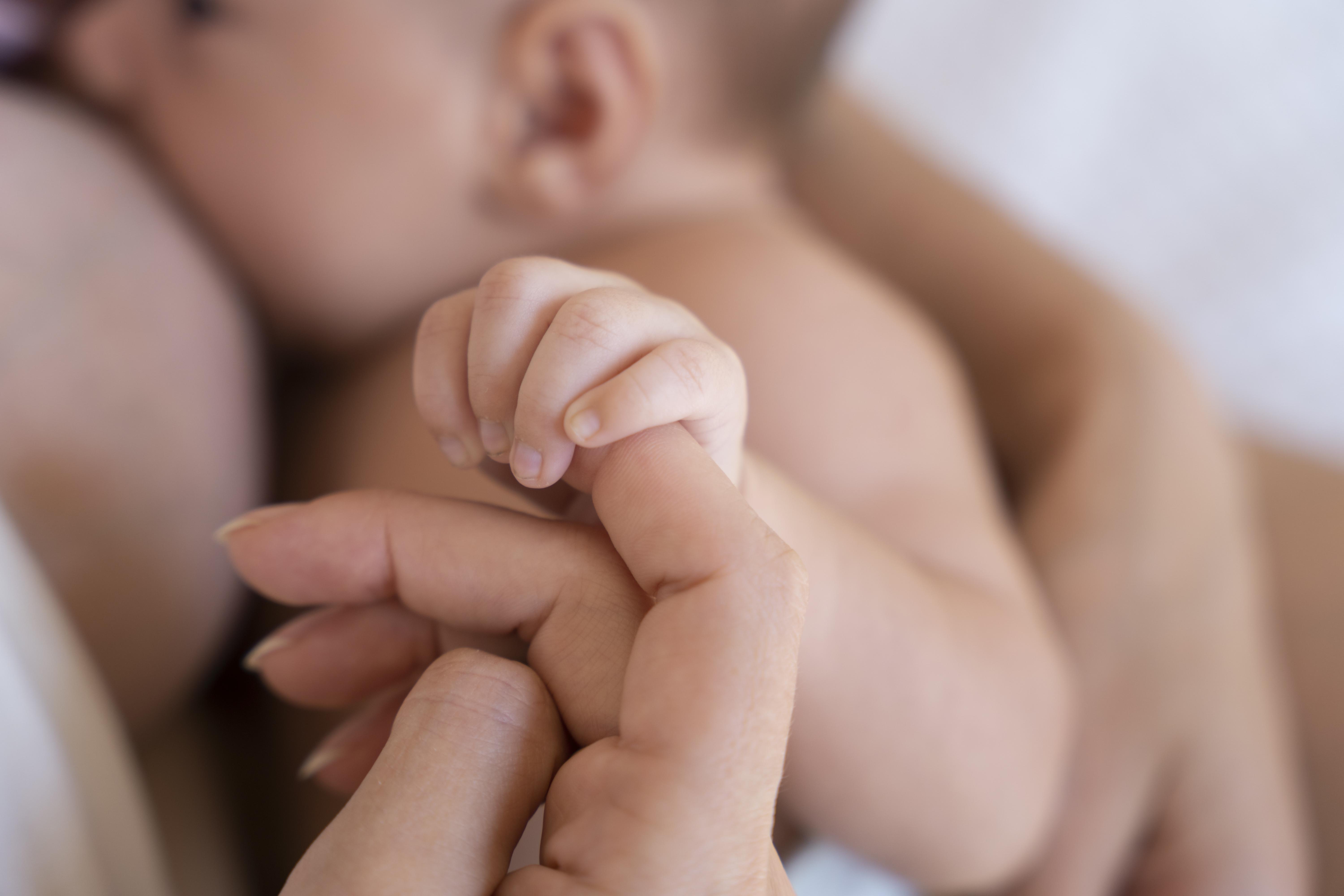 A mother during the postnatal period with her baby