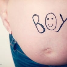 pregnant tummy with writing saying boy